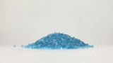 Pile of blue Emperor Melt ice melt granules on a white background.