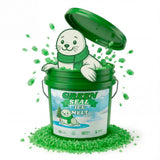 Seal cartoon popping out of a Green Seal Ice Melt pail full of green granules.