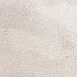 Close-up of white calcium chloride pellets.
