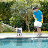 Man pouring dissolved pool salt from a bucket into a pool beside a Pool Salt bag.